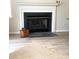 Cozy living room with a classic fireplace and neutral-toned tile flooring at 5702 Burning Ridge Dr, Monroe, NC 28110