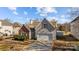 Aerial view of a single Gathering home, featuring a well manicured lawn and attached two-car garage at 5720 Parkstone Dr, Matthews, NC 28104