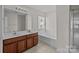 Bathroom features a double sink vanity, soaking tub, and separate shower at 5720 Parkstone Dr, Matthews, NC 28104