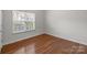 A bright bedroom with hardwood floors and a window at 5720 Parkstone Dr, Matthews, NC 28104