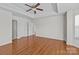 Spacious bedroom with ceiling fan, natural light, and access to an ensuite bathroom at 5720 Parkstone Dr, Matthews, NC 28104