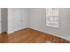 A bedroom with hardwood floors, a window and a closet at 5720 Parkstone Dr, Matthews, NC 28104