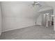 Spacious upstairs bonus room with neutral carpet at 5720 Parkstone Dr, Matthews, NC 28104