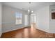 Well-lit dining room with hardwood floors, white trim, and access to the rear yard at 5720 Parkstone Dr, Matthews, NC 28104