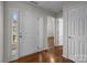 Bright entryway featuring hardwood floors, white trim, and a view into the living area at 5720 Parkstone Dr, Matthews, NC 28104