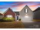 Charming two-story home with a brick and vinyl exterior and well-maintained landscaping at 5720 Parkstone Dr, Matthews, NC 28104