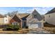 Home exterior with brick and vinyl siding, featuring a garage and meticulously maintained lawn at 5720 Parkstone Dr, Matthews, NC 28104