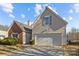 Two-story home showcasing a two-car garage and well-manicured landscaping at 5720 Parkstone Dr, Matthews, NC 28104