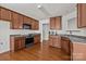 This kitchen features stainless steel appliances, wood cabinets and hardwood floors at 5720 Parkstone Dr, Matthews, NC 28104