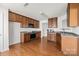 Well-equipped kitchen features wood cabinets, stainless steel appliances, and hardwood floors at 5720 Parkstone Dr, Matthews, NC 28104