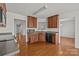 Modern kitchen boasts wood cabinetry, gray countertops, and stainless steel appliances, perfect for cooking at 5720 Parkstone Dr, Matthews, NC 28104