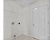 Laundry room features washer and dryer hookups and wire shelving at 5720 Parkstone Dr, Matthews, NC 28104