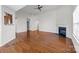 Bright living room featuring hardwood floors, a ceiling fan, and a fireplace for a cozy ambiance at 5720 Parkstone Dr, Matthews, NC 28104