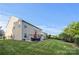Large backyard with a well-maintained lawn, patio furniture, and mature trees at 6112 Canyon Trl, Denver, NC 28037
