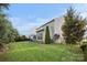 View of the home's siding, well-maintained lawn, mature trees, and fenced backyard at 6112 Canyon Trl, Denver, NC 28037