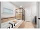 Modern bathroom featuring a soaking tub and glass enclosed shower at 6112 Canyon Trl, Denver, NC 28037