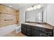 Modern bathroom featuring a double vanity, tile flooring, and a bathtub with tile surround at 6112 Canyon Trl, Denver, NC 28037