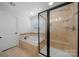 Bright bathroom featuring tiled shower, a soaking tub and window at 6112 Canyon Trl, Denver, NC 28037