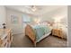 Cozy bedroom with a wooden bed frame, light-colored walls, and natural light from the window at 6112 Canyon Trl, Denver, NC 28037