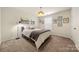 Comfortable bedroom with modern decor, neutral tones, and plush carpeting at 6112 Canyon Trl, Denver, NC 28037
