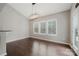 Bright dining area with three windows, elegant lighting, and hardwood floors at 6112 Canyon Trl, Denver, NC 28037