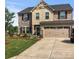 Charming two-story home with a combination of brick and siding and a well-manicured lawn at 6112 Canyon Trl, Denver, NC 28037