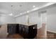 Spacious kitchen island with stone countertops and dark cabinets, perfect for entertaining and meal preparation at 6112 Canyon Trl, Denver, NC 28037