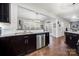 Open-concept kitchen area with stainless steel appliances, modern countertops and dark cabinetry at 6112 Canyon Trl, Denver, NC 28037
