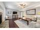 Comfortable living room featuring a cozy fireplace, entertainment center, and neutral color palette at 6112 Canyon Trl, Denver, NC 28037