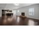 Open concept living area with a modern kitchen and stone fireplace, perfect for entertaining guests at 6112 Canyon Trl, Denver, NC 28037