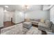 Living room with a large grey couch, ottoman, and hardwood floors at 6112 Canyon Trl, Denver, NC 28037