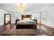 Spacious main bedroom with hardwood floors, plantation shutters, and neutral decor at 6112 Canyon Trl, Denver, NC 28037