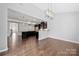Open concept living space featuring a modern kitchen with a large island and dark cabinets at 6112 Canyon Trl, Denver, NC 28037