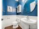 Charming powder room with blue walls, a round mirror and pedestal sink at 6112 Canyon Trl, Denver, NC 28037