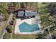 Aerial view of a house with an enclosed pool covered for the off-season at 653 Camrose Ne Cir, Concord, NC 28025