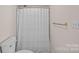 Basic bathroom with a white shower curtain, toilet, and neutral wall color at 653 Camrose Ne Cir, Concord, NC 28025