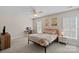 Well-lit bedroom with a desk, comfortable bed, and ample natural light from two windows at 653 Camrose Ne Cir, Concord, NC 28025