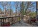 Relaxing outdoor deck with wood flooring and seating area, surrounded by trees at 653 Camrose Ne Cir, Concord, NC 28025