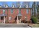 Charming multi-story brick townhome featuring dormer windows and well-maintained landscaping at 653 Camrose Ne Cir, Concord, NC 28025