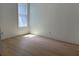 Empty bedroom with light hardwood floors and natural light streaming through the window at 6855 Union Rd, Gastonia, NC 28056