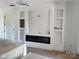 Bright living room featuring custom built-ins, a modern fireplace, and recessed lighting at 6855 Union Rd, Gastonia, NC 28056