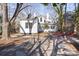 Charming backyard with a cozy fire pit area, surrounded by mature trees and a well-maintained lawn at 85 Grove Nw Ave, Concord, NC 28025