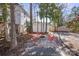 Inviting backyard featuring a cozy fire pit surrounded by modern red seating, trees and landscaping at 85 Grove Nw Ave, Concord, NC 28025