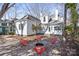 Backyard featuring a fire pit with modern red seating, surrounded by a pea gravel and paved area at 85 Grove Nw Ave, Concord, NC 28025