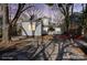 Private backyard featuring a stone patio, seating area, and mature trees, perfect for outdoor entertaining and relaxation at 85 Grove Nw Ave, Concord, NC 28025