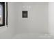 Bright tiled shower in the bathroom with black window frame at 85 Grove Nw Ave, Concord, NC 28025