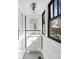 Bright bathroom featuring a glass shower, white vanity with black trim and a large window for natural light at 85 Grove Nw Ave, Concord, NC 28025