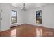 Bright bedroom with hardwood floors, a chandelier, and large windows offering ample natural light at 85 Grove Nw Ave, Concord, NC 28025