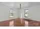 Bright bedroom with hardwood floors, a chandelier, and large windows offering ample natural light at 85 Grove Nw Ave, Concord, NC 28025