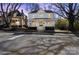 Charming two-story home with a welcoming front porch, enhanced by mature trees and a well-maintained lawn at 85 Grove Nw Ave, Concord, NC 28025